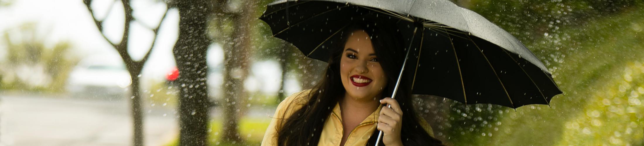 student holding umbrella in the rain