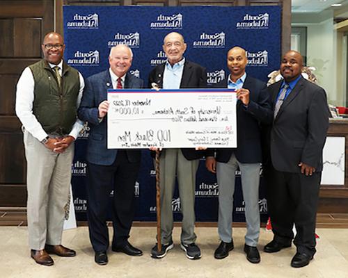 President Bonner, Dr. Mitchell, Dr. Greene, and member of 100 Black Men donating check to USA.