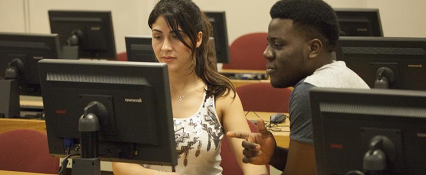 A male and female student working on computer